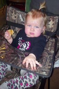 Shelby enjoying a cookie in ciao! baby chair